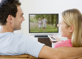 Woman relaxing at home watching tv